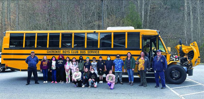 kids in front of a new electric school bus in Cherokee as part of the Native Electric Project